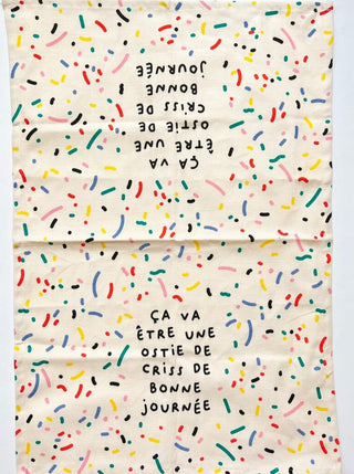 Linge à vaisselle motif confeti avec les couleurs primaires inscrit: ça va être une ostie de criss de bonne journée. Parfait idée cadeau pour femme. Fait au Québec.